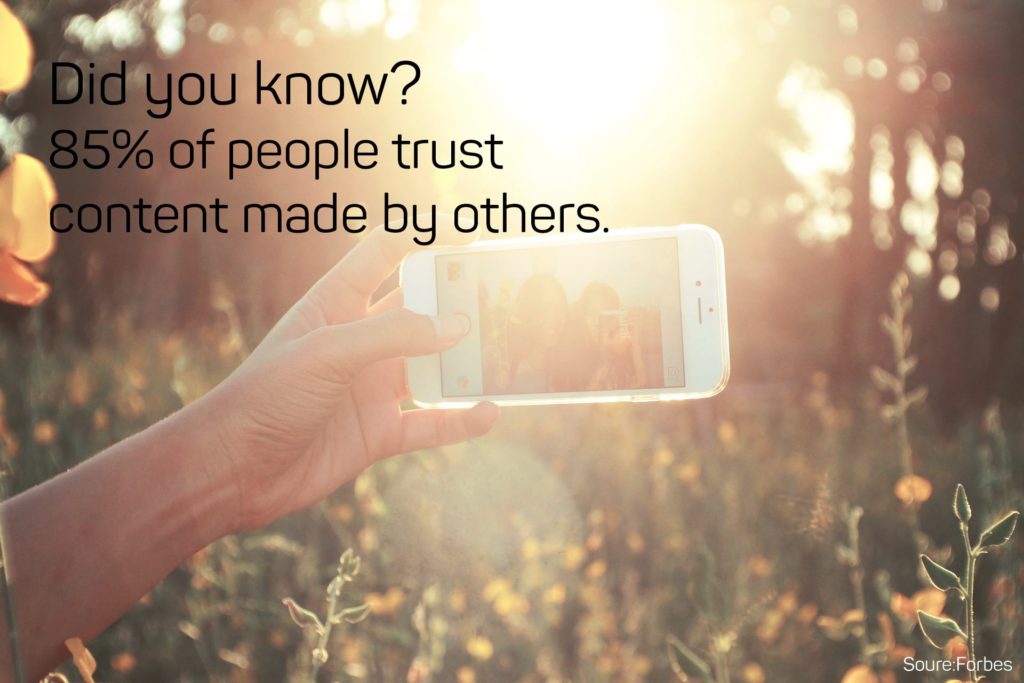 This is a photo of someone taking a selfie with the following marketing tip: "Did you know? 85% of people trust content made by others."